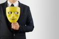 Businessman holds mask