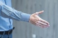 Businessman holds out his hand for a handshake Royalty Free Stock Photo