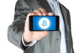 Businessman holds smart phone with Bitcoin symbol Royalty Free Stock Photo