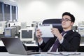 Businessman holds tablet and leans on office chair Royalty Free Stock Photo