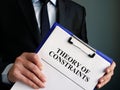 Businessman holds toc theory of constraints papers Royalty Free Stock Photo