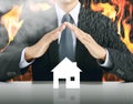 Businessman and home with fire background Royalty Free Stock Photo