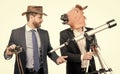 Businessman in horse head mask hold telescope and cowboy man with binoculars, business vision