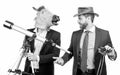 Businessman in horse head mask hold telescope and cowboy man with binoculars, business vision