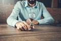 Businessman with hourglass on desk Royalty Free Stock Photo