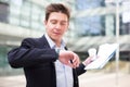 Businessman hurrying to meeting and watching on wristwatch