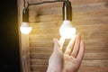 The light is on in the hand. A glowing light bulb in his hand Royalty Free Stock Photo