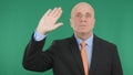 Businessman Image Making Hello Hand Gestures with Green Background