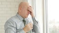 Businessman Image Suffering a Headache with a Glass with Water in Hand