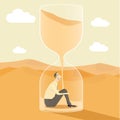 Businessman inside hourglass.