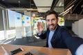 Businessman inside office taking selfie, scared mature man looking into smartphone camera, waving hand greeting, using Royalty Free Stock Photo