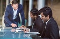 Businessman interacting with coworkers in a meeting in the conference room Royalty Free Stock Photo