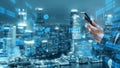 Modern Businessman Using Smartphone with Digital Data Overlay Against Urban Skyline at Night for Technology and Royalty Free Stock Photo