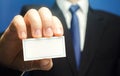 Businessman introduces himself with a business card. Presentation, hands over contacts to client. Agent offers his services.