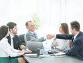 Businessman and investor shake hands at the negotiating table Royalty Free Stock Photo