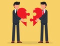 Businessman joining together heart shaped jigsaw puzzle.Business metaphor of a joint venture