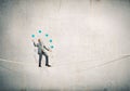 Businessman juggling with balls