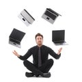 Businessman juggling with laptops Royalty Free Stock Photo