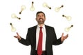 Businessman Juggling Multiple Lightbilbs