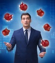 Businessman juggling with piggybanks in business concept Royalty Free Stock Photo