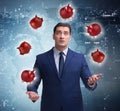 Businessman juggling with piggybanks in business concept Royalty Free Stock Photo