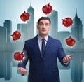 Businessman juggling with piggybanks in business concept Royalty Free Stock Photo