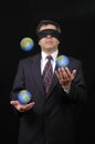 Businessman juggling with planet earth