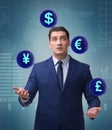 Businessman juggling between various currencies Royalty Free Stock Photo