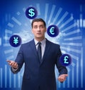 Businessman juggling between various currencies Royalty Free Stock Photo