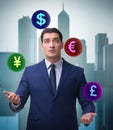 Businessman juggling between various currencies Royalty Free Stock Photo