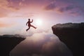 Businessman jumping from cliff on beautiful sky background. Gap, leap and success concept Royalty Free Stock Photo