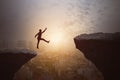 Businessman jumping from cliff on sky and city background. Gap, leap, risk, challenge and success concept Royalty Free Stock Photo