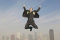 Businessman Jumping In Joy Above City Royalty Free Stock Photo