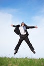 Businessman jumping on the meadow Royalty Free Stock Photo