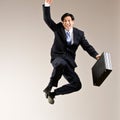 Businessman jumping in mid-air cheering Royalty Free Stock Photo