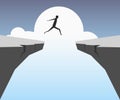 Businessman jumping over chasm