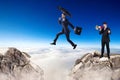 Businessman jumping over a cliff and collegue is cheering with bullhorn.