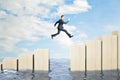 Businessman jumping over obstacles between wooden chart bars above water on bright blue sky background. Challenge and success