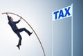 Businessman jumping over tax in tax evasion avoidance concept Royalty Free Stock Photo