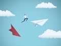 Businessman jumping between paper planes. Business symbol or metaphor for risk, danger, change, escape or bankruptcy and