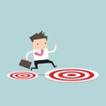 Businessman jumping from small target to the big target