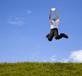 Businessman jumping with tablet pc