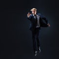 Businessman jumping up. Young man in business suit seeking higher ambition concept. Royalty Free Stock Photo