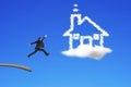 Businessman jumping from wooden board to house shape cloud