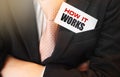 Businessman keeps card with How it works text. in upper pocket of his suit Business project concept