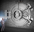 Businessman with key near bank vault door Royalty Free Stock Photo