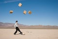 Businessman kicking boxes