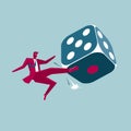 Businessman kicks a huge dice.