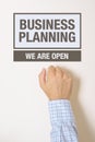 Businessman knocking on Business Planning Office door