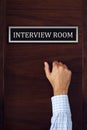 Businessman knocking on interview room door